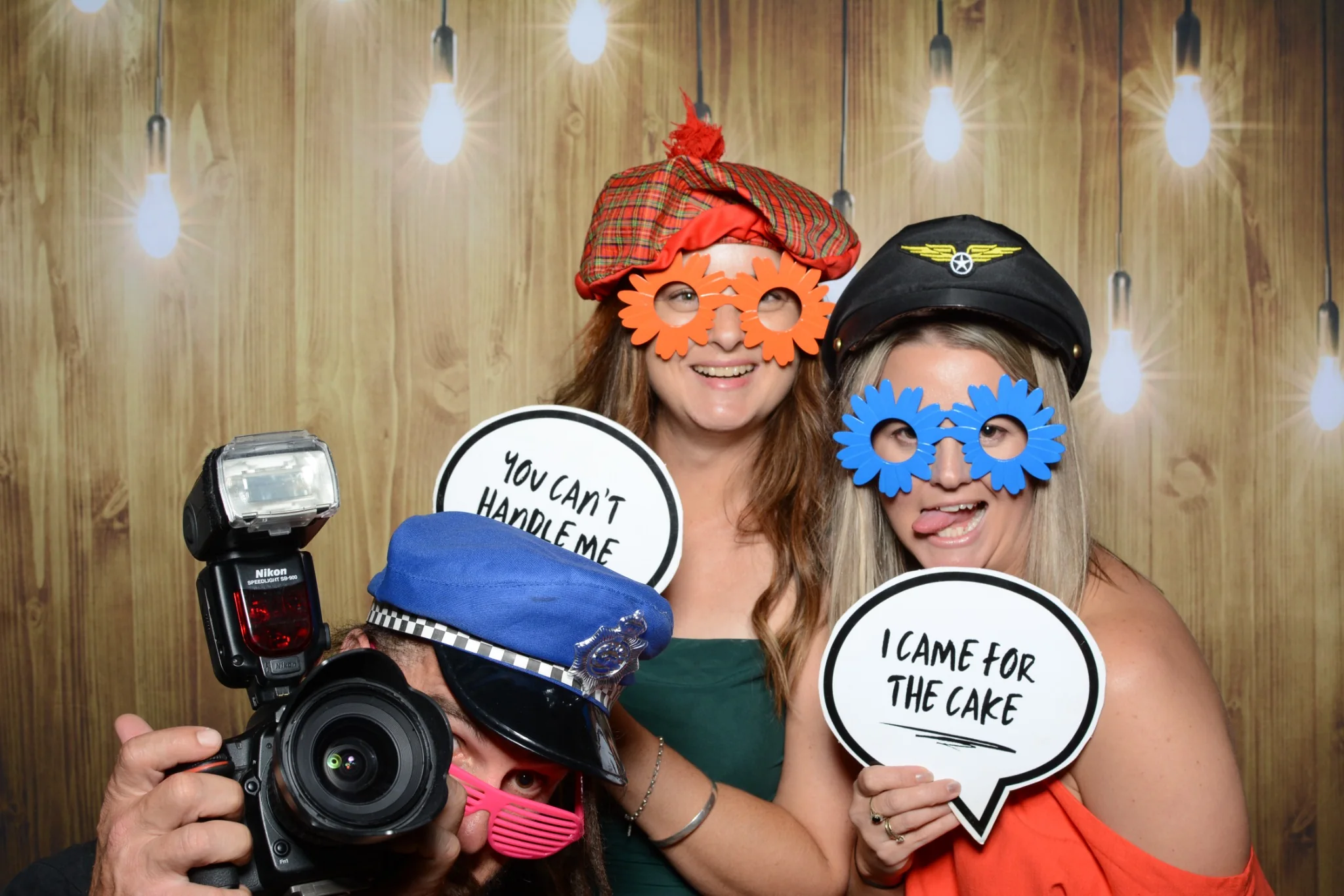 Party guests getting creative with photo booth props