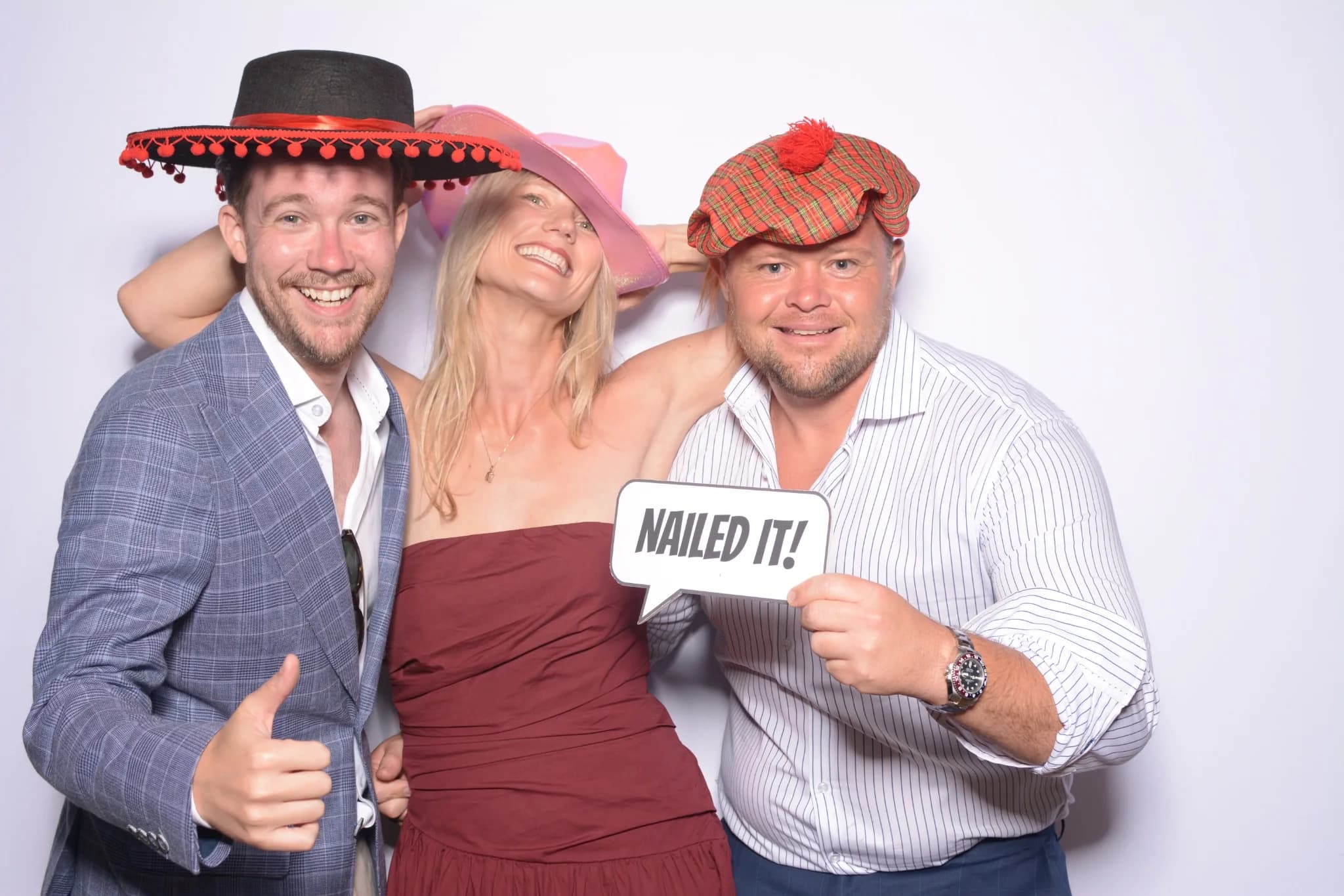 Dressed-up guests posing together at a photo booth