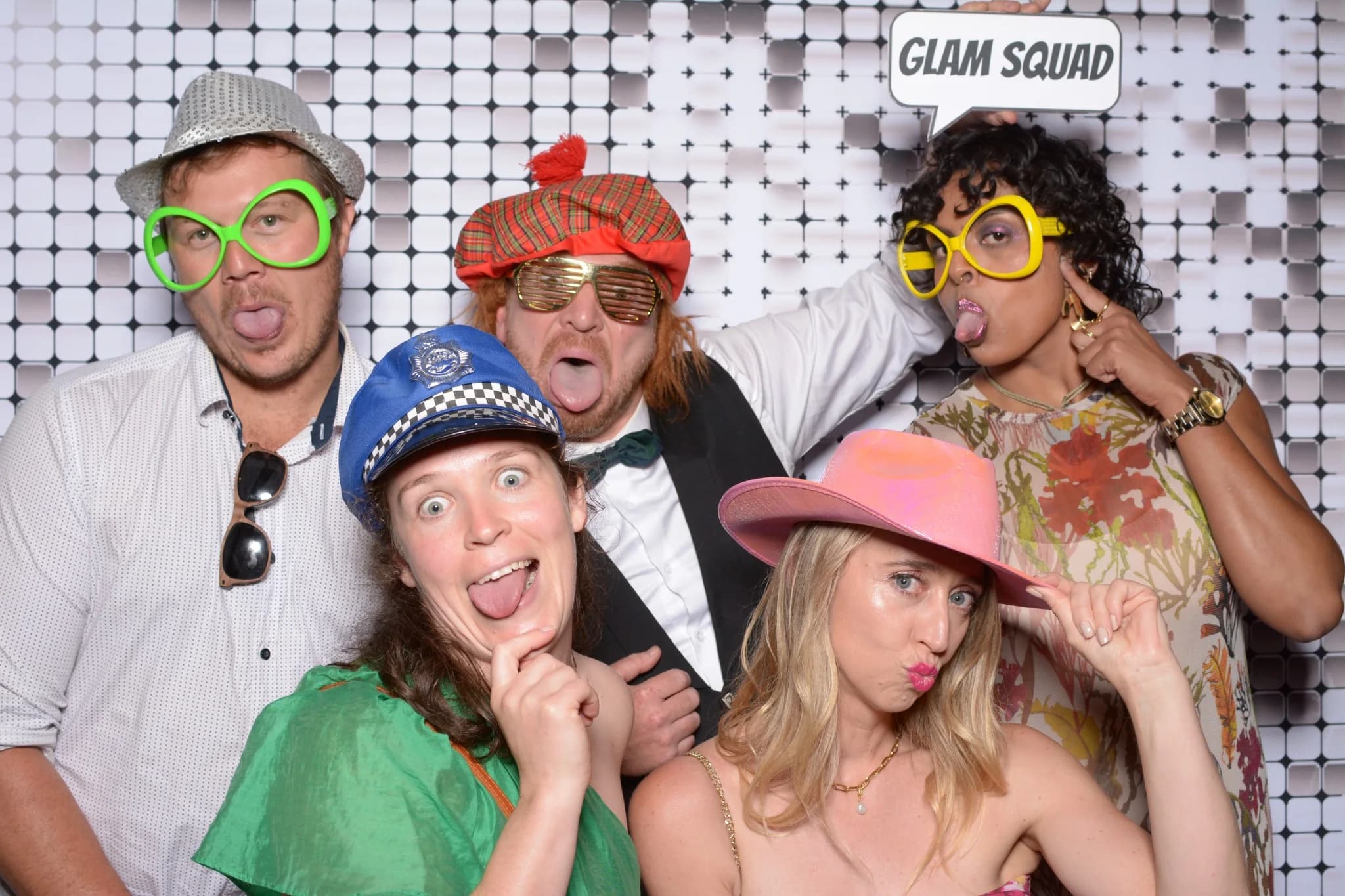 Friends enjoying a dressed-up celebration in the photo booth